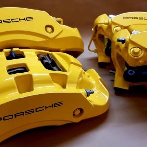 Porsche yellow brake caliper refurbishment and painting with black stenciling london