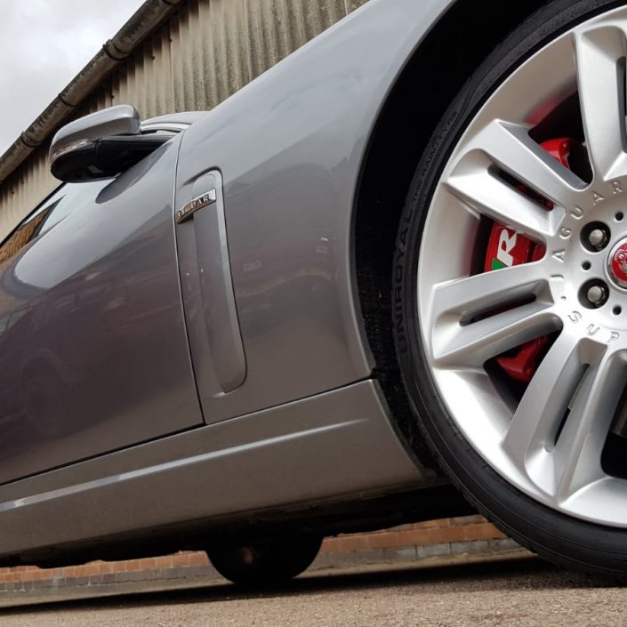 Jaguar XKR silver alloy wheel refurbishment Nottingham and red brake caliper painting Derby